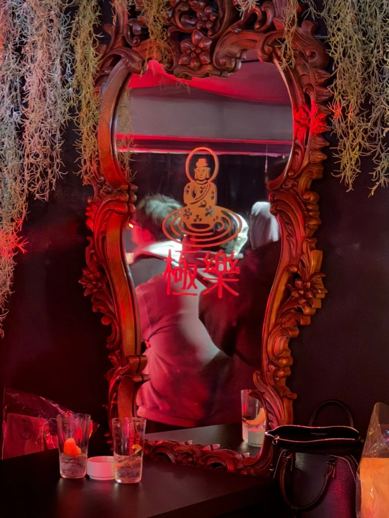 Audience enjoying the show reflected in Sukha's logo mirror