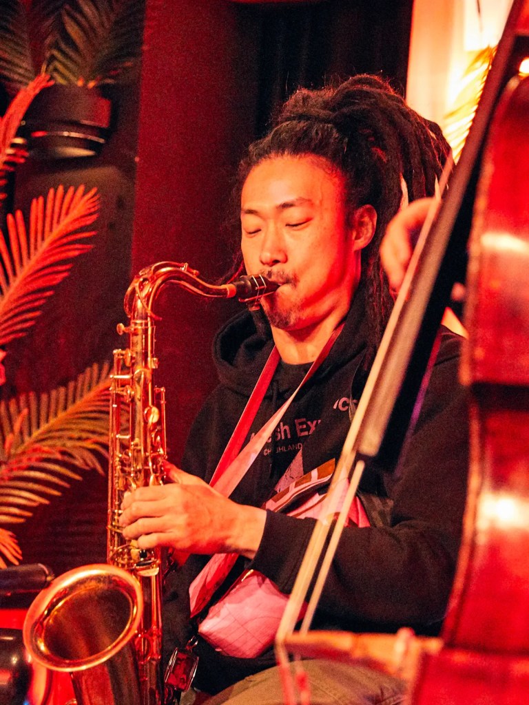 Musician playing saxophone on Sukha's stage